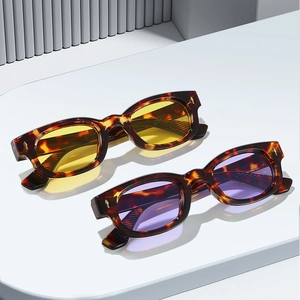 Vintage square tortoiseshell sunglasses with yellow and purple lenses on geometric podium