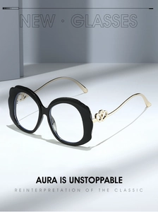 Close-up of stylish round black frame glasses with gold metal heart-shaped temple detail