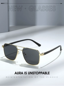 Detail of classic pilot sunglasses with gold metal frame and dark grey lenses