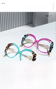 Close-up of golden metal hinges with double heart cutouts on stylish eyewear frames