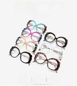 Detail of stylish oversized eyewear featuring unique double heart metal cutout hinges
