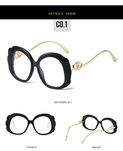 Detail view of scalloped edge glasses frame with heart-shaped gold metal temples