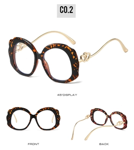 Detailed views of tortoise shell glasses with golden heart metal temples and wavy frame
