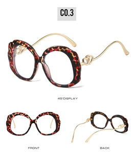 Detailed views of tortoise shell round frames with golden heart pattern hinges