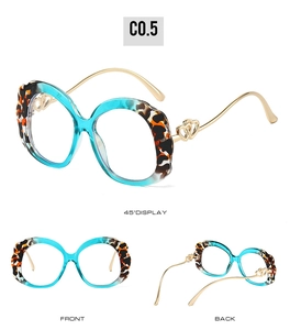 Detail view of blue transparent and tortoiseshell frames with heart metal hinges