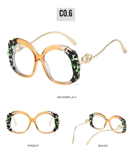 Detail view of tortoiseshell frames with gold temples and double heart hinges