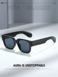 Detail view of bold square sunglasses with thick black frames and blue lenses