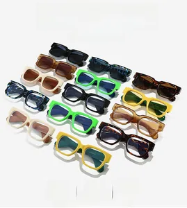 Multiple colorful square frame sunglasses in leopard, green, and yellow on white background