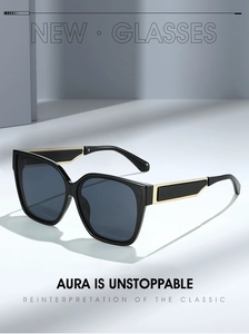 Detail of square sunglasses with black frame and golden metal temple accents