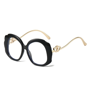 Fashionable black wavy round frame blue light glasses with gold heart detail temples