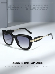 Detail of oversized sunglasses with purple gradient lenses and gold metal arrow hinge