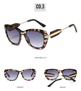 Detail view of tortoiseshell sunglasses featuring purple gradient lenses and gold temple accents