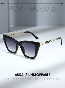 Detail of cat eye sunglasses featuring gold metal temples with hollow geometric patterns