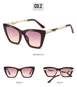 Detail of burgundy cat-eye sunglasses with gradient lenses and golden wing temple details