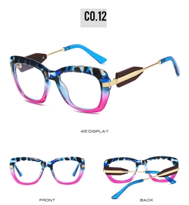 Detail view of large cat-eye sunglasses with blue tortoiseshell and rose red frames