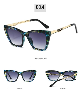Detail view of cat eye sunglasses with blue marble frames and purple gradient lenses