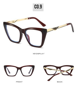 Detail view of cat eye sunglasses with tortoise frame and ornate gold metal temples