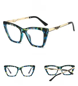 Detail of cat-eye sunglasses featuring blue tortoiseshell frames and gold hollow temples