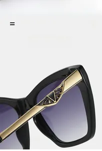 Detail of bold black frames with golden metal temples featuring triangular hollow patterns