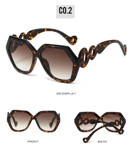 Detailed view of tortoiseshell polygon sunglasses with hollow circular temple design