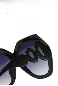 Detail of wavy temples and gradient lenses on oversized fashion sunglasses