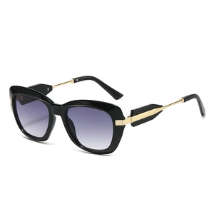Stylish oversized cat-eye sunglasses with purple gradient lenses and gold arrow temples