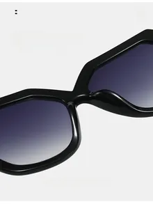 Detail view of ergonomic nose pads on oversized black sunglasses with purple lenses