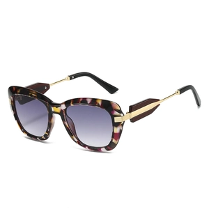 Oversized tortoise shell sunglasses with purple gradient lenses and gold metal arms