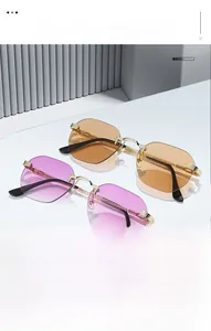Detail of rimless octagonal sunglasses with gradient purple and brown lenses on white stand