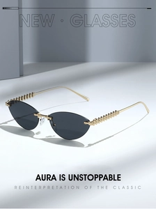 Detail of rimless cat-eye sunglasses with gold pyramid studs on metallic temples