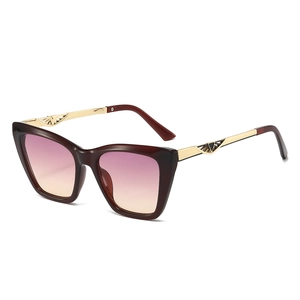 Fashionable cat-eye sunglasses with gradient lenses and gold wing-shaped metal temples