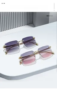 Detail view of rimless rectangle sunglasses with metal temples and gradient lenses