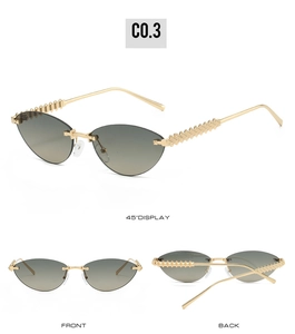 Detail showing cat eye rimless sunglasses with gold metal studs and grey gradient lenses