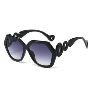Fashion hexagon sunglasses with black frames, cutout temples and purple gradient lenses