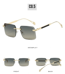Detail view of rimless rectangular sunglasses with gold metal temples and gradient grey lenses