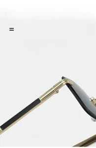 Macro detail of rimless sunglasses featuring gold metal temples and high-quality hinges