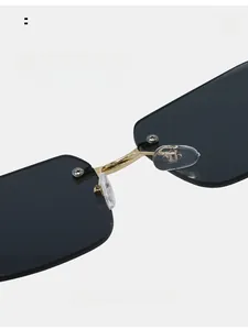 Close-up of comfortable silicone nose pads on rimless sunglasses with gold metal bridge