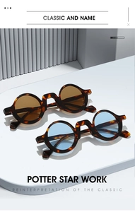 Detail view of round tortoiseshell sunglasses with brown and blue lenses on a pedestal