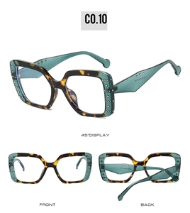 Detail view of square tortoiseshell sunglasses with blue temples and metal studs