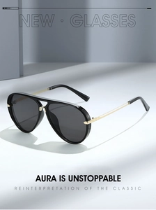 Close-up of classic aviator sunglasses with black frames and gold metal temples