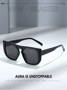 Close-up of stylish black square oversized sunglasses with glossy frames and dark lenses