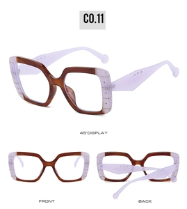 Detail view of square tortoiseshell sunglasses with metal stud accents and purple arms