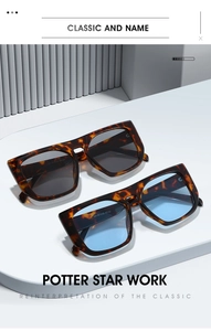 Close-up of tortoise shell square sunglasses with dark grey and light blue lenses