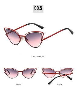 Detail of red hollow double frame cat eye sunglasses with purple gradient lenses