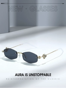 Close-up of golden hinges with rhinestone flower detail on rimless polygon sunglasses