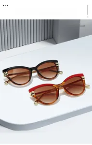 Close-up of cat-eye sunglasses with tortoise shell temples and gold metal accents