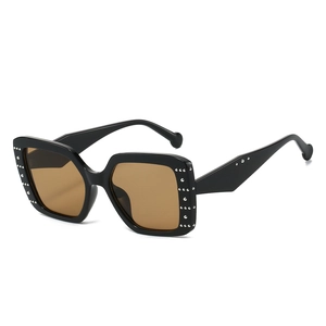Modern square black sunglasses with silver studs and brown lenses at a 45-degree angle