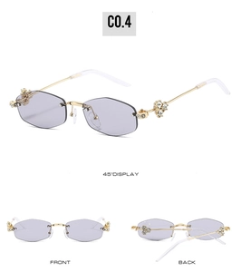 Detail of luxury rimless hexagonal sunglasses with gold metal arms and crystal accents