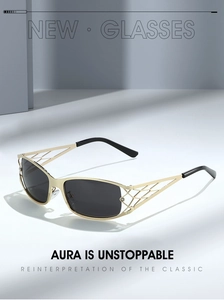 Detail of Y2K sunglasses with golden metal cutout hollow frames and dark lenses