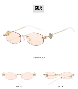 Detail view of pink rimless sunglasses with gold floral rhinestone accents